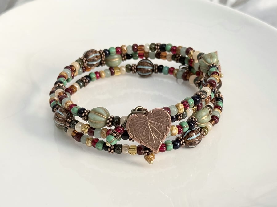 Bohemian inspired multicoloured beaded wrap bracelet with copper leaf charms