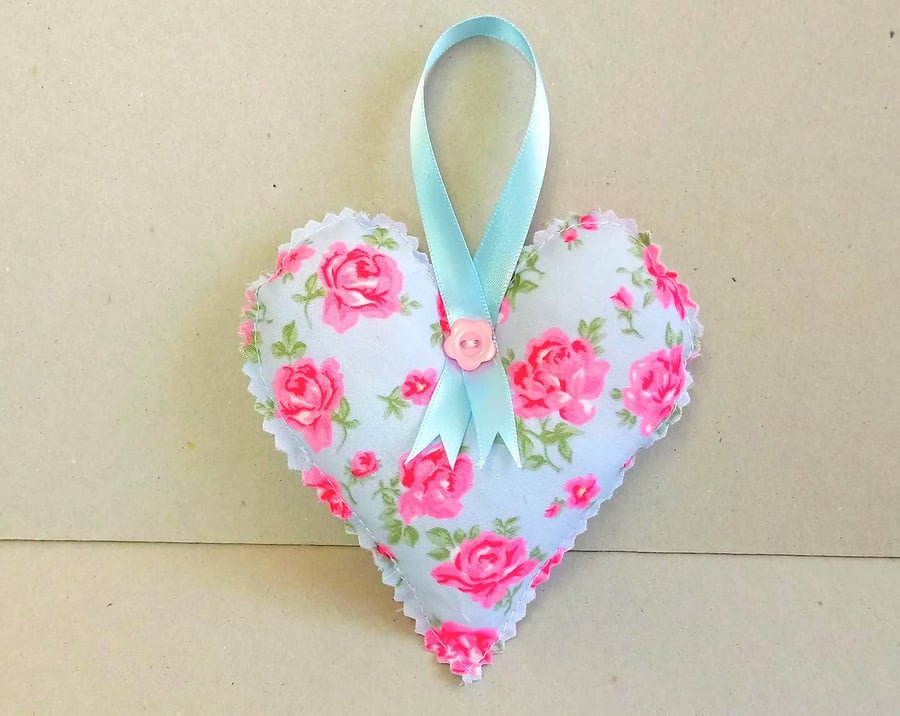 Blue heart decoration with pink flowers and hanging ribbon