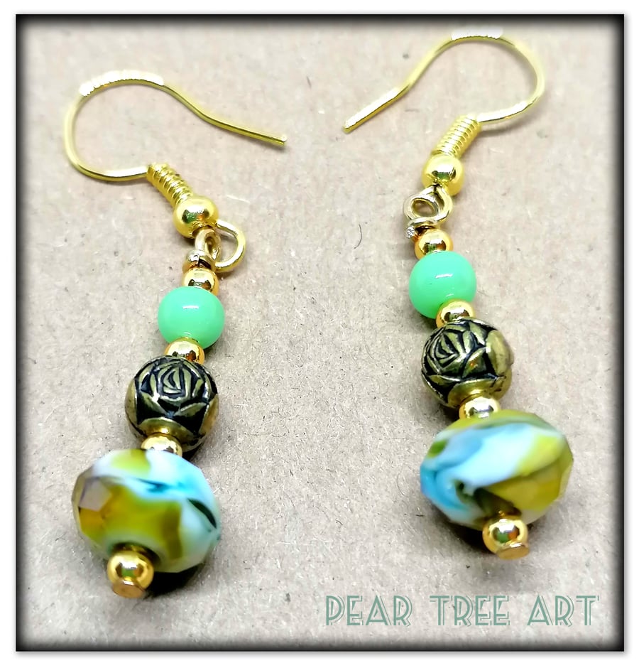 Small green crystal glass bead earrings on gold plated hooks.