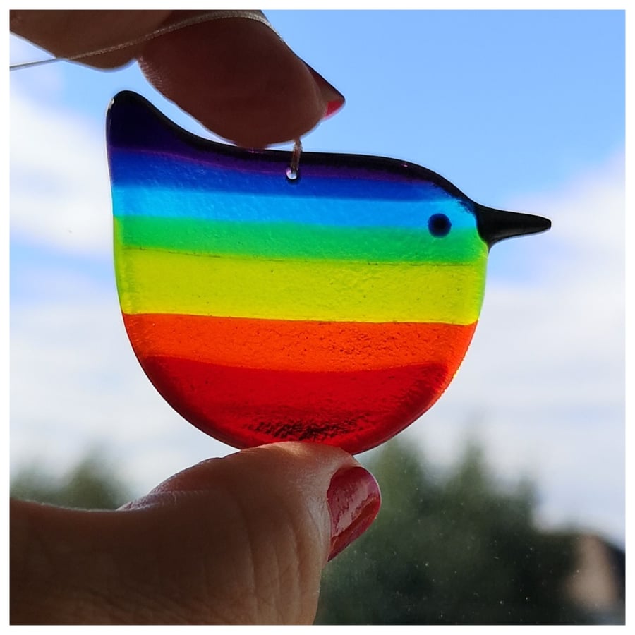A rainbow wren of hope glass bird with dark purple back
