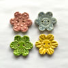 Set of four flower shaped ceramic handmade buttons