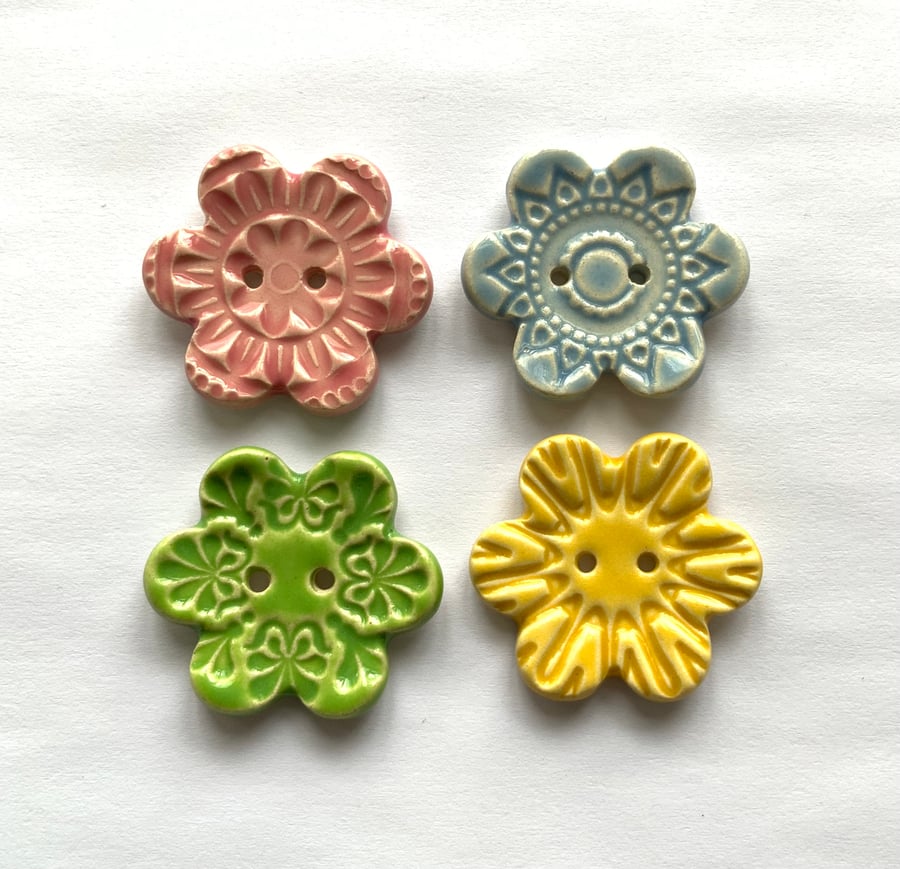 Set of four flower shaped ceramic handmade buttons