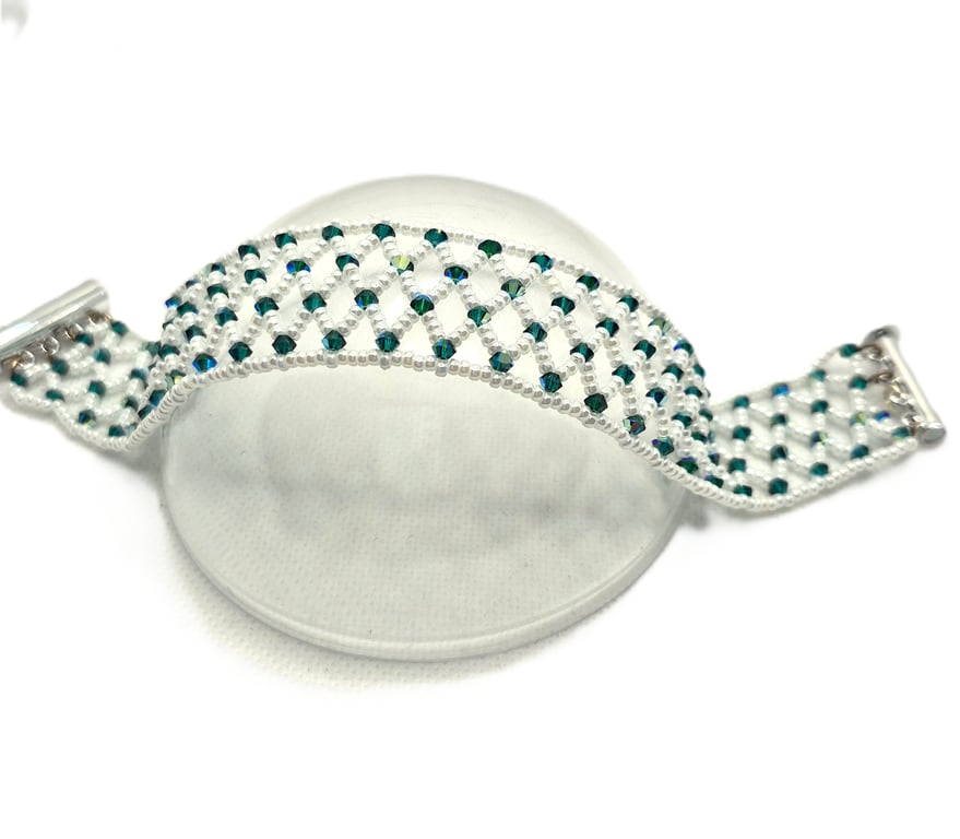 White seed bead netted cuff style bracelet with green Swarovski crystals