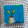 Hope seedling collage on thick reclaimed wooden block