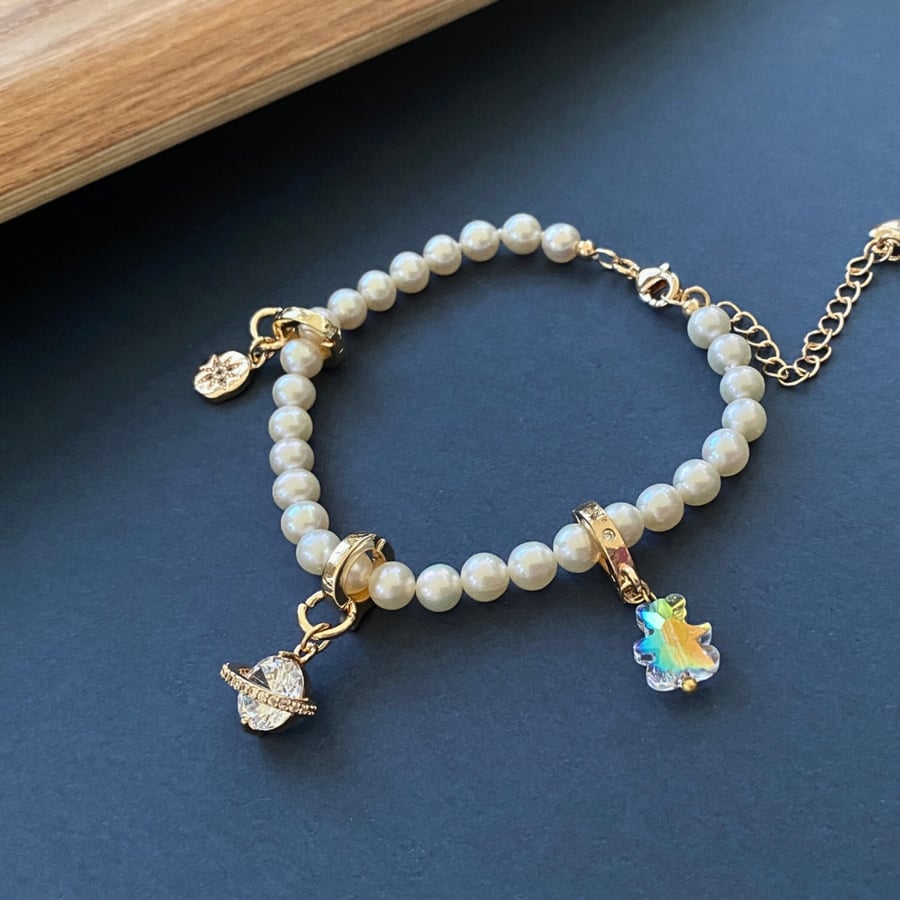 Lovely Freshwater Pearl with three charms bracelet in gold plated