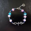 Silver paw and heart charm bracelet with blue and pink beads and lobster clasp