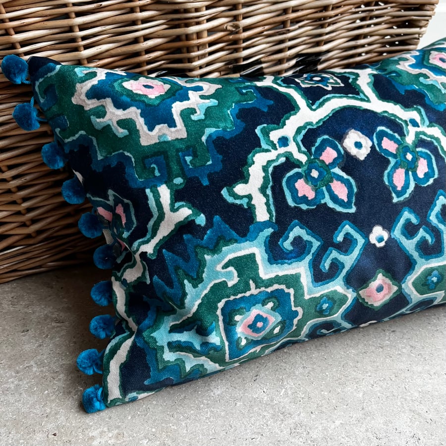 Blue and green velvet cushion with pompoms colourful home