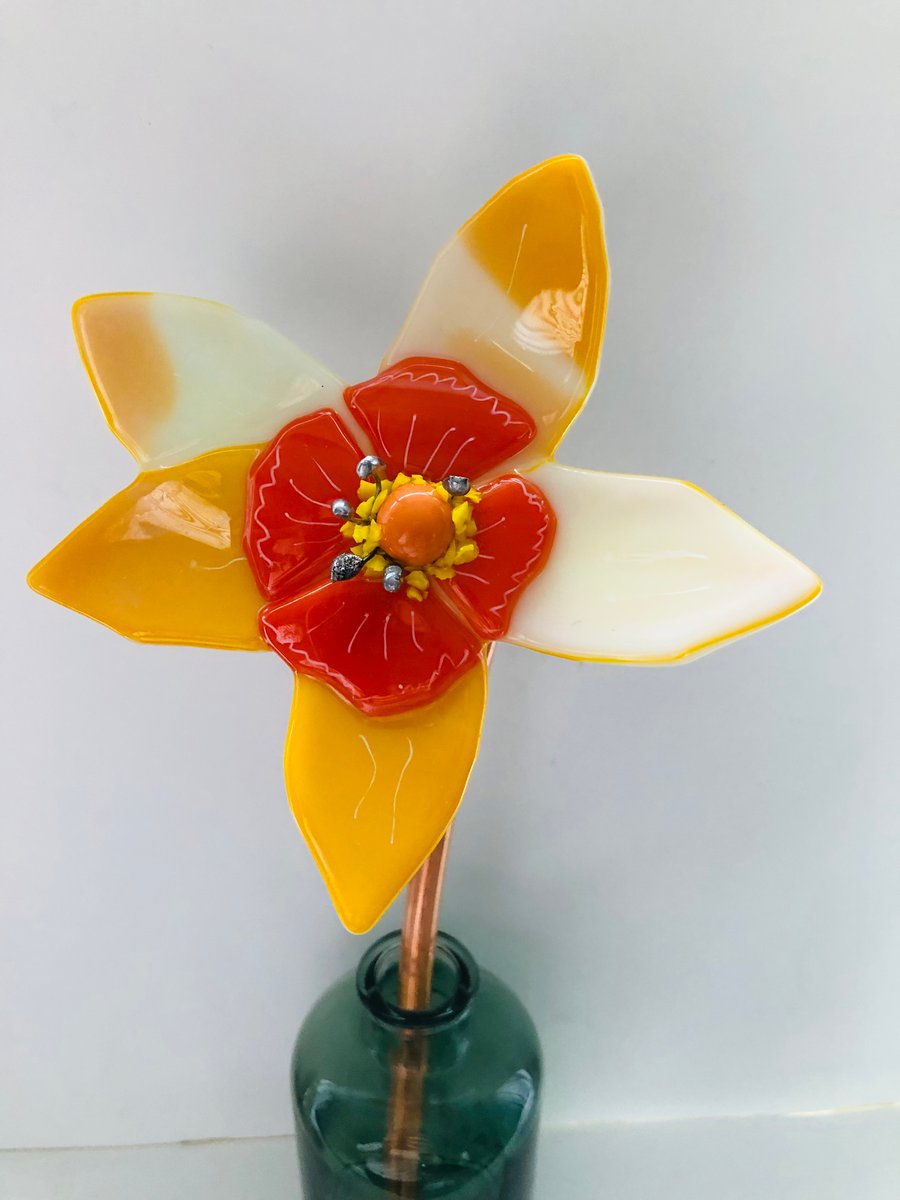 Glass fused yellow flower daffodil style attached to copper pipe