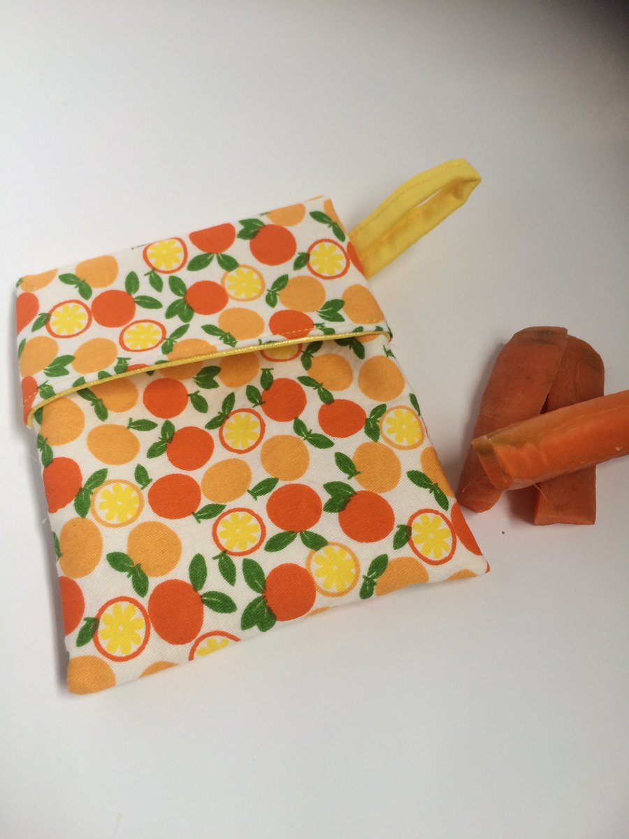 Large reusable snack holder for food on the go. Oranges fabric and PUL lining