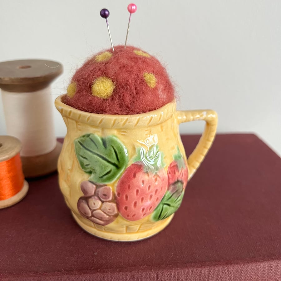 Needle felted pin cushion in repurposed jug with strawberry design