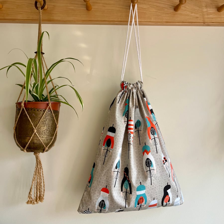 Cycling print cotton drawstring bag with spotty cotton lining