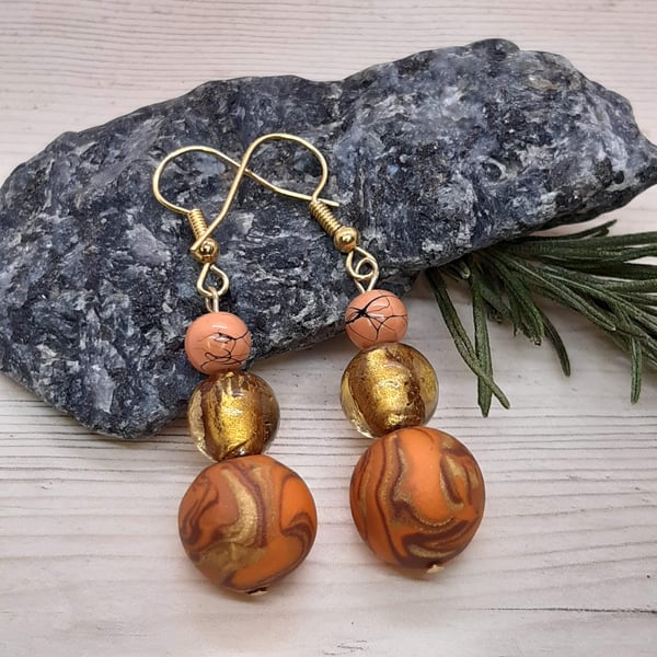 Earrings in burnt orange, brown and gold