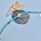 Aquamarine Glass Bead & Cowrie Shell Bracelet with Sterling Silver Detail.