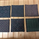 Set of six navy fabric coasters with sashiko embroidery detail 