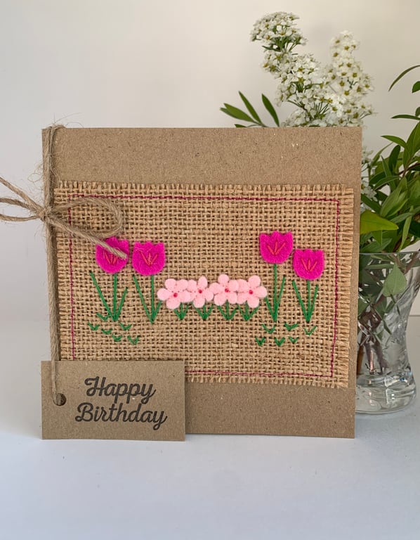 Handmade birthday card. Row of pretty pink flowers from wool felt.