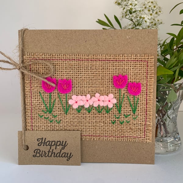 Handmade birthday card. Row of pretty pink flowers from wool felt.