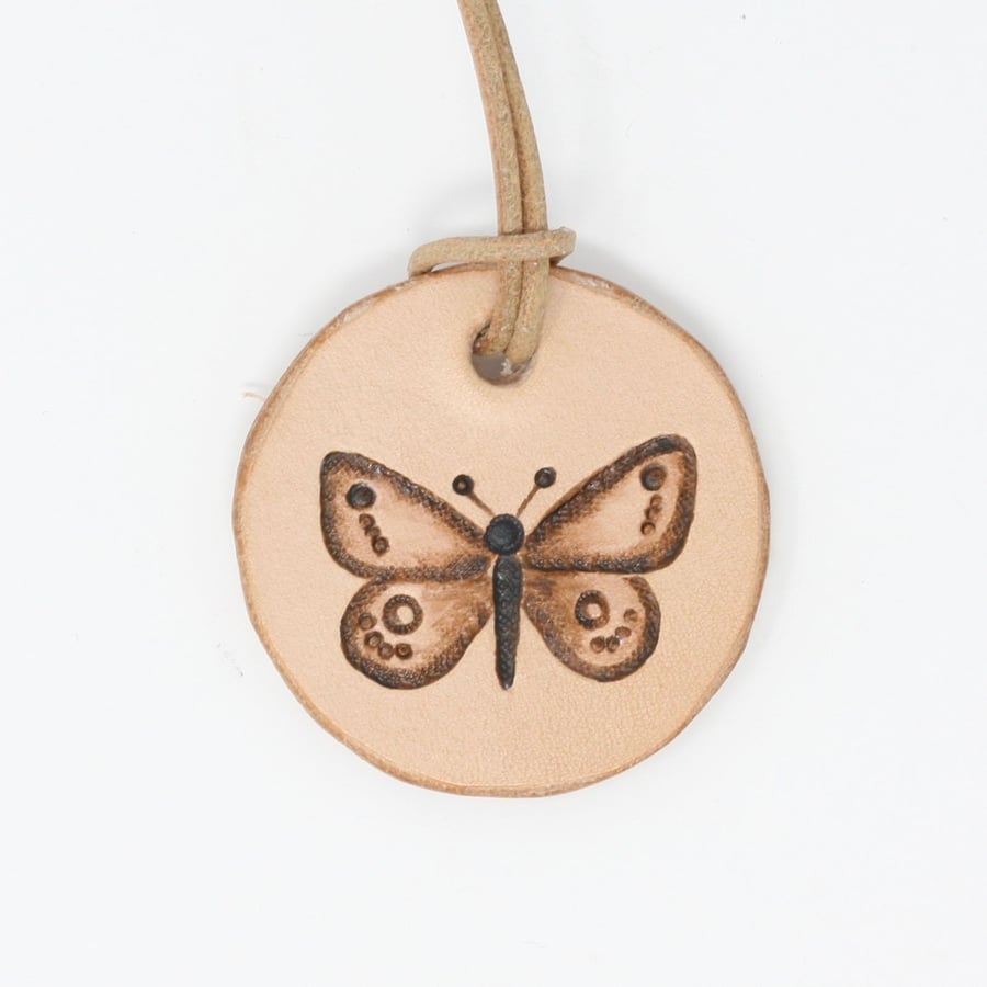 Leather pendant with butterfly motif