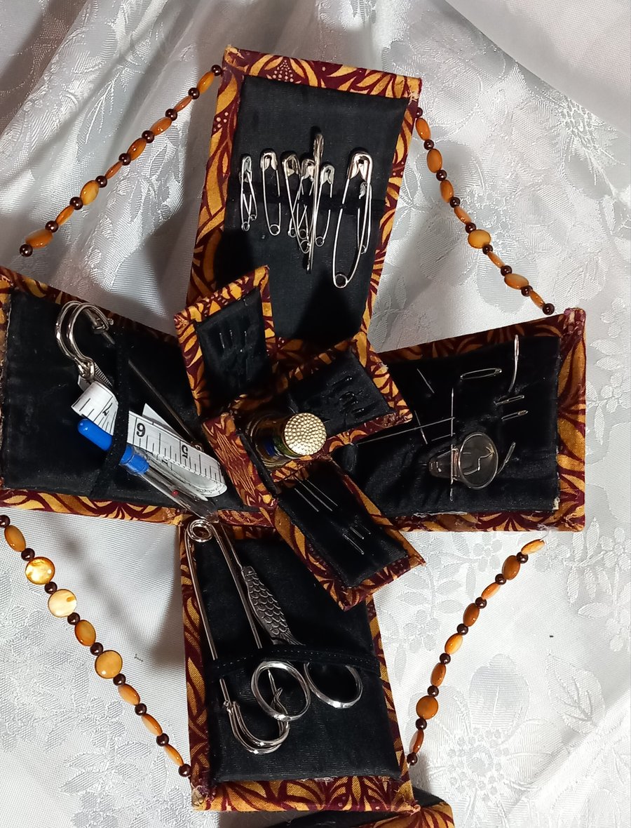 Handmade mini sewing box that unfolds to reveal everything for sewing tasks.