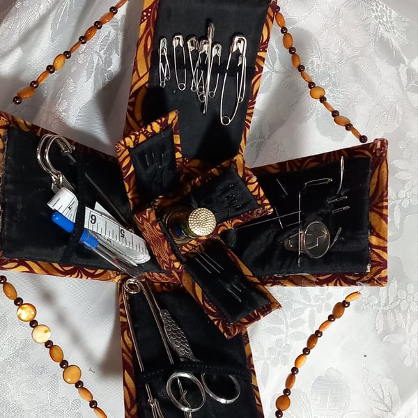Handmade mini sewing box that unfolds to reveal everything for sewing tasks.