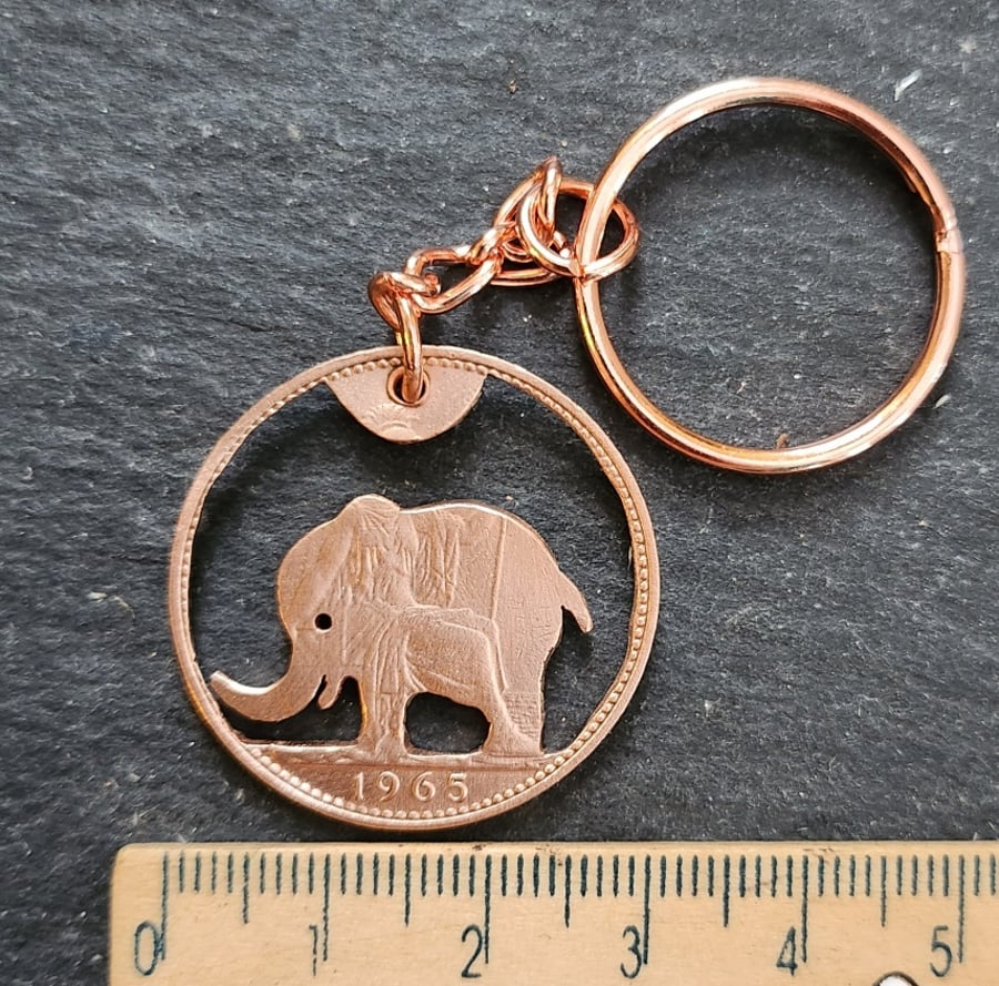 Upcycled 1965 penny coin with pierced elephant