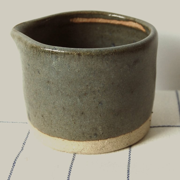 Dark green matt glazed ceramic milk pourer