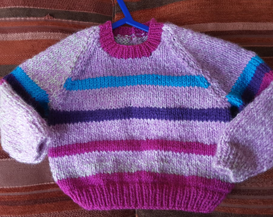Pretty pink striped hand knitted baby jumper