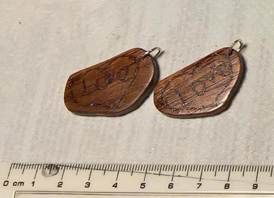 Pendant mahogany , with the word LOVE carved on one side and
