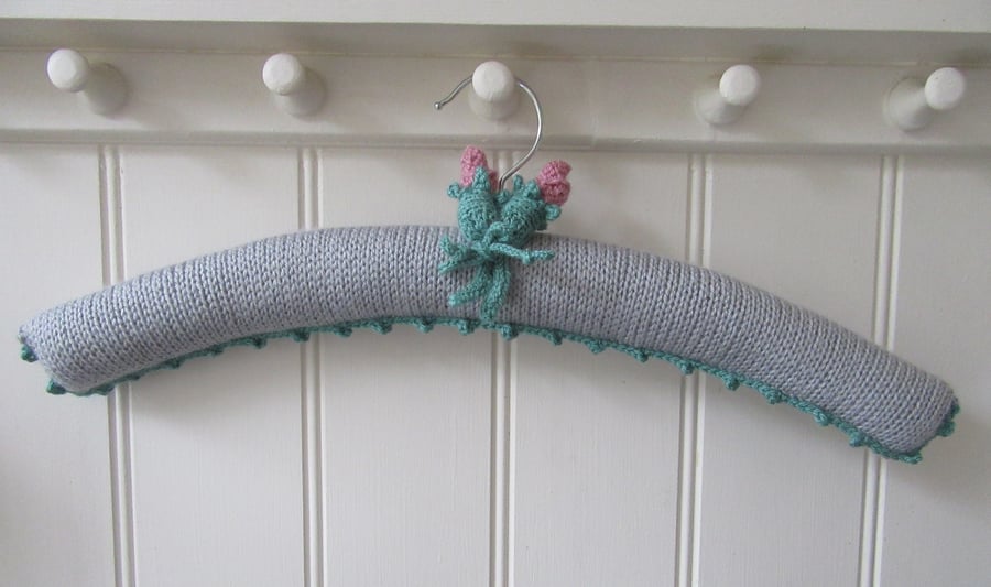 Hand knitted padded silver grey coat hanger with rose buds