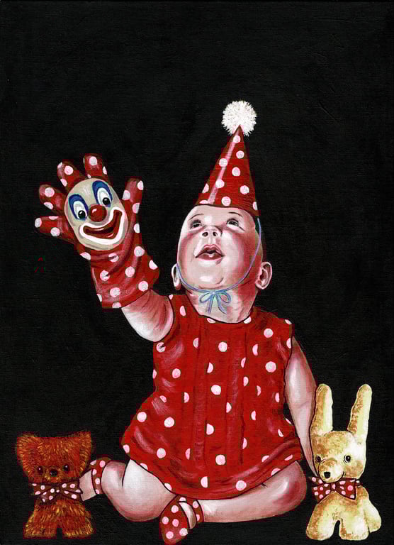 Baby with clown glove puppet