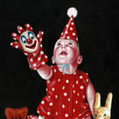 Baby with clown glove puppet