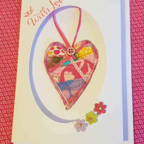 Textile heart decoration in a card