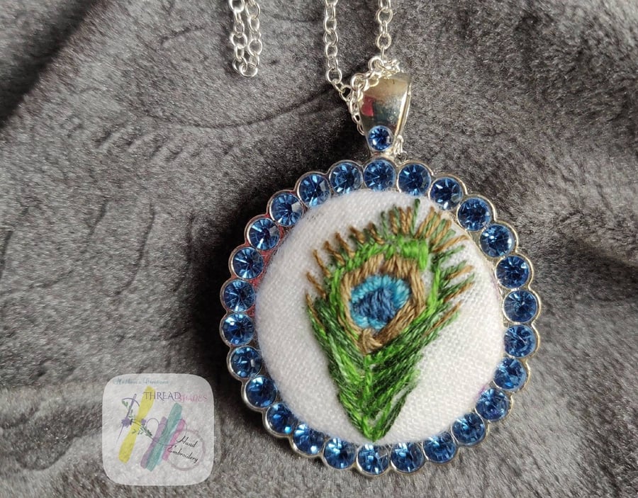 Hand embroidered pendant, peacock feather embroidery, circle shape, silver color