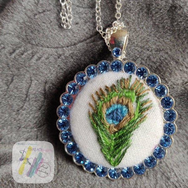 Hand embroidered pendant, peacock feather embroidery, circle shape, silver color
