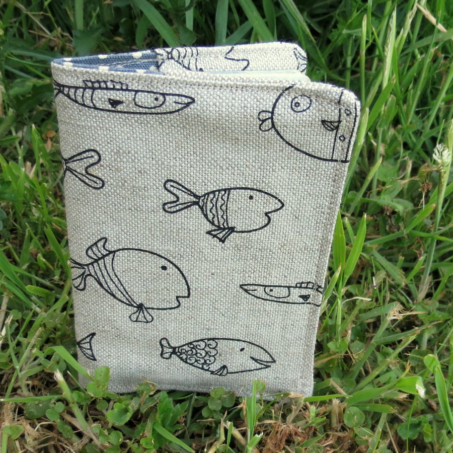 A fabric passport cover with a fish design.  Passport Sleeve.
