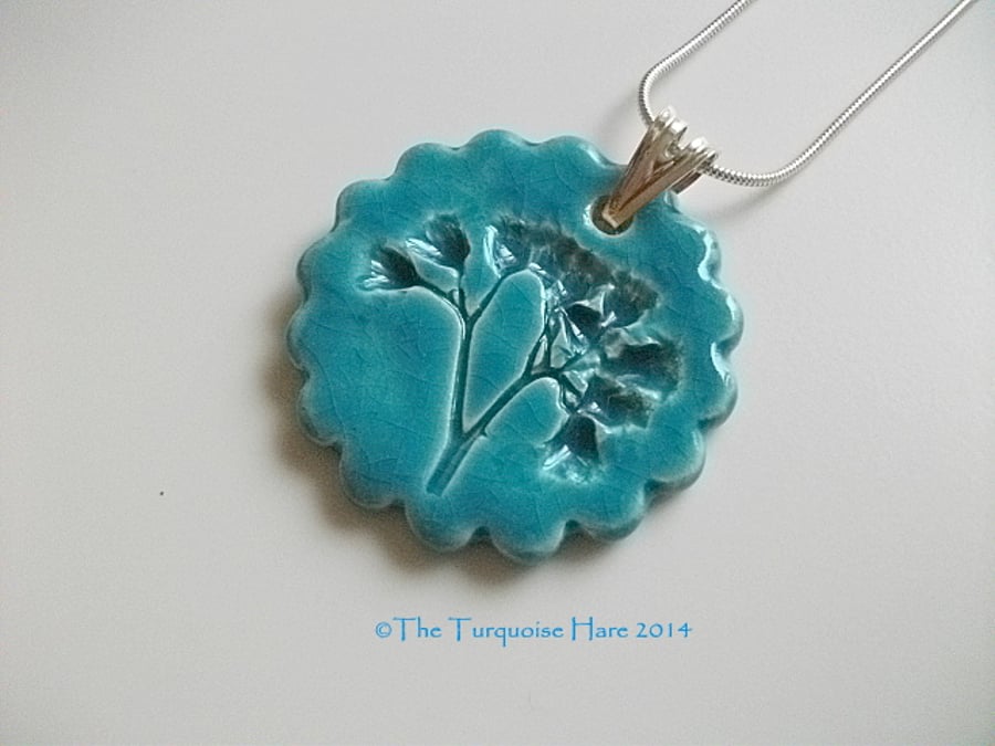 Ceramic turquoise pendant impressed with "weeds" -  sterling silver