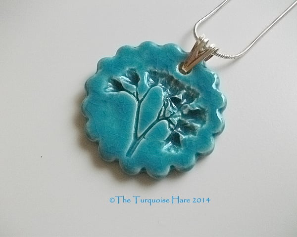 Ceramic turquoise pendant impressed with "weeds" -  sterling silver