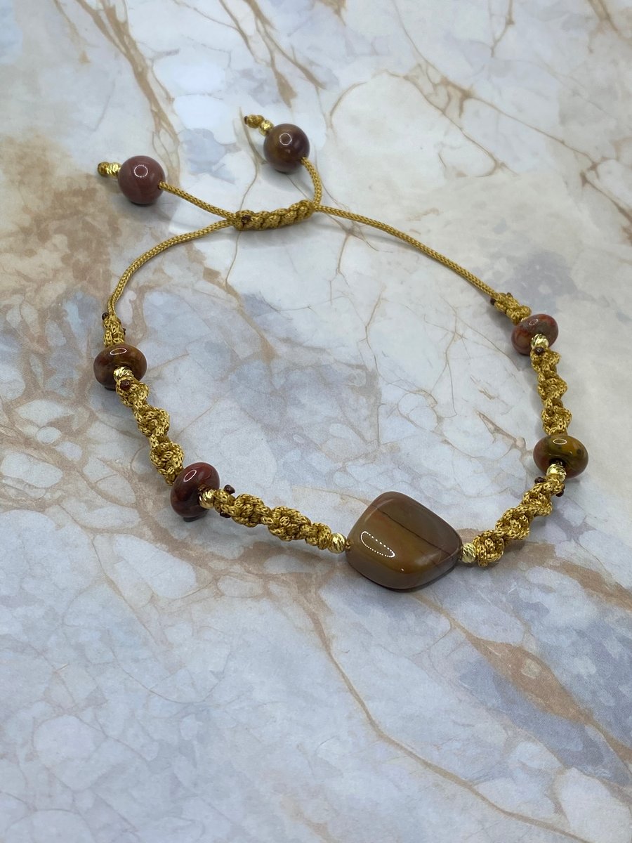 Gold tone macrame cord bracelet with nuggets of mookaite stone