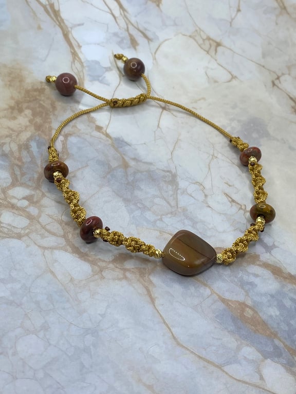 Gold tone macrame cord bracelet with nuggets of mookaite stone