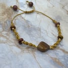 Gold tone macrame cord bracelet with nuggets of mookaite stone