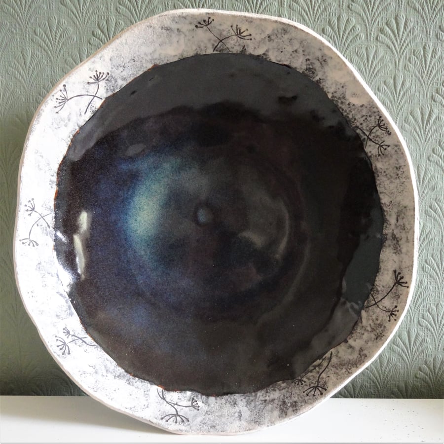 Decorative large ceramic bowl.  Freeform, shallow, blue and white, seed motifs. 