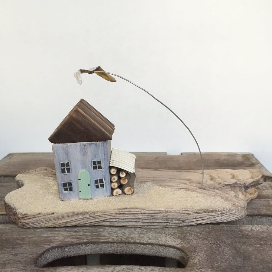 Handmade cottage on driftwood