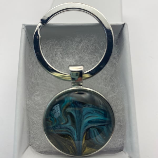 Key ring with acrylic fluid art pendant in silver coloured setting 