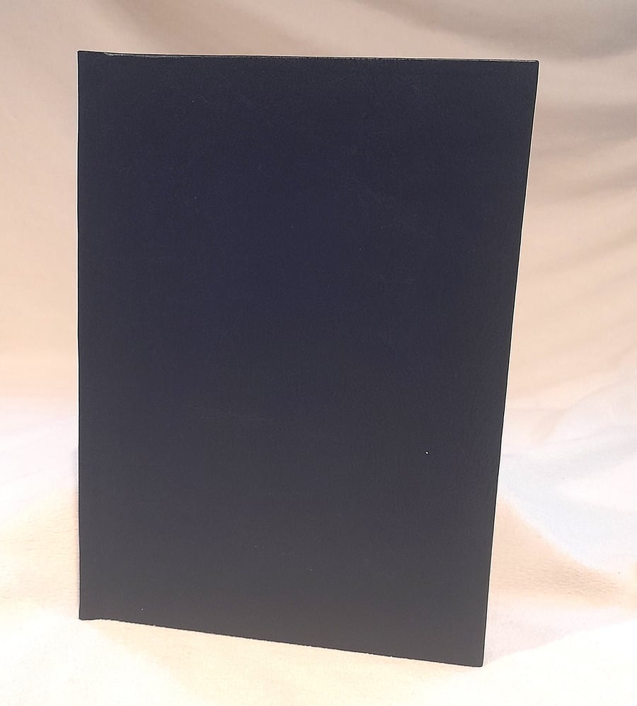 A5 notebook bound with dark blue bookcloth and orange star endpapers