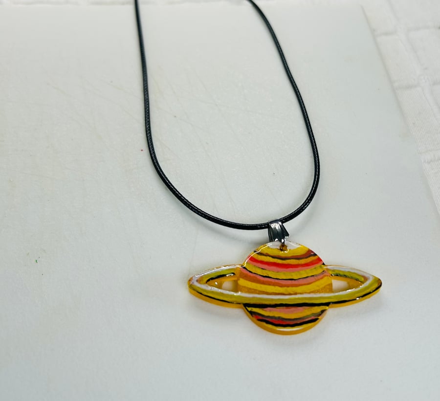 A hand painted and resin layered pendant necklace by Andrew Jenkins 