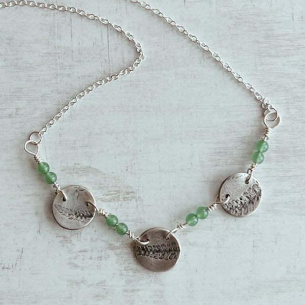 Botanical silver pendant with fern design and aventurine.