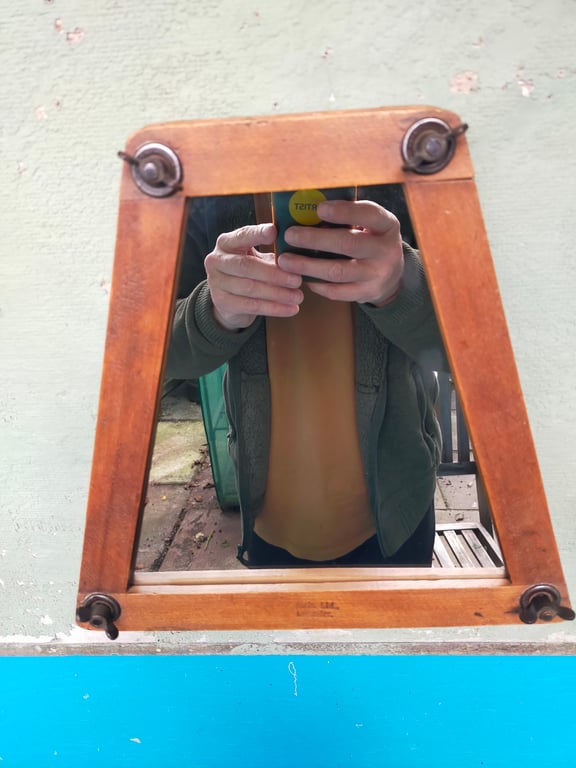 Vintage tennis racket press mirror.