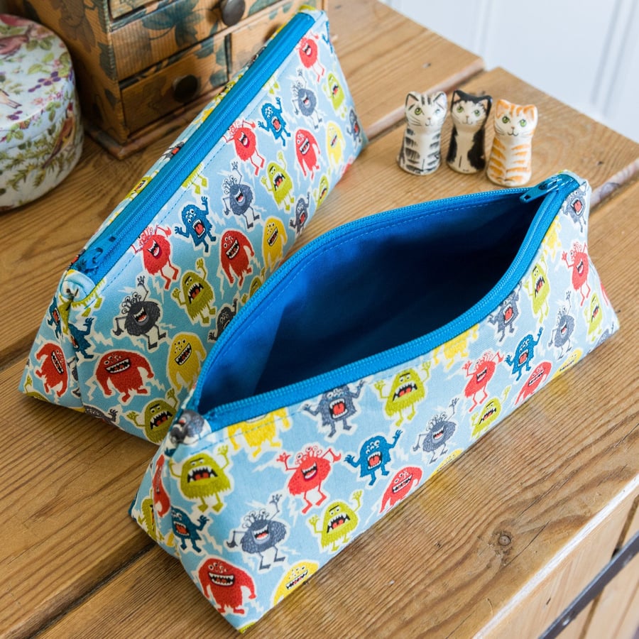 Zip pouch made with colourful fun monsters print in a really useful size,