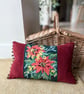 Orange and yellow floral tapestry cushion with pompoms