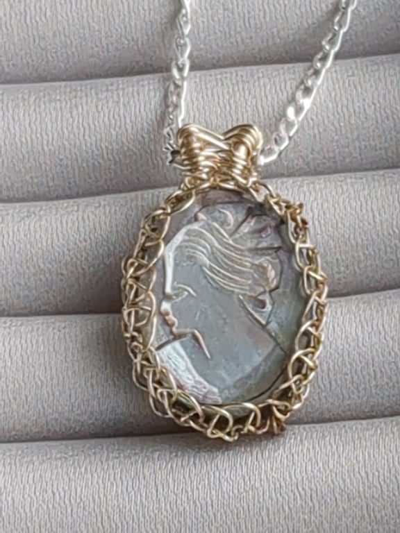 Black mother of pearl cameo netted in silver plated copper wire pendant 