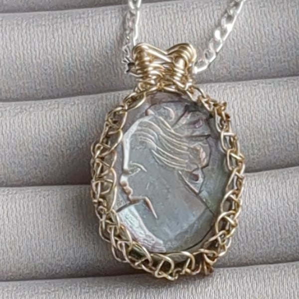 Black mother of pearl cameo netted in silver plated copper wire pendant 